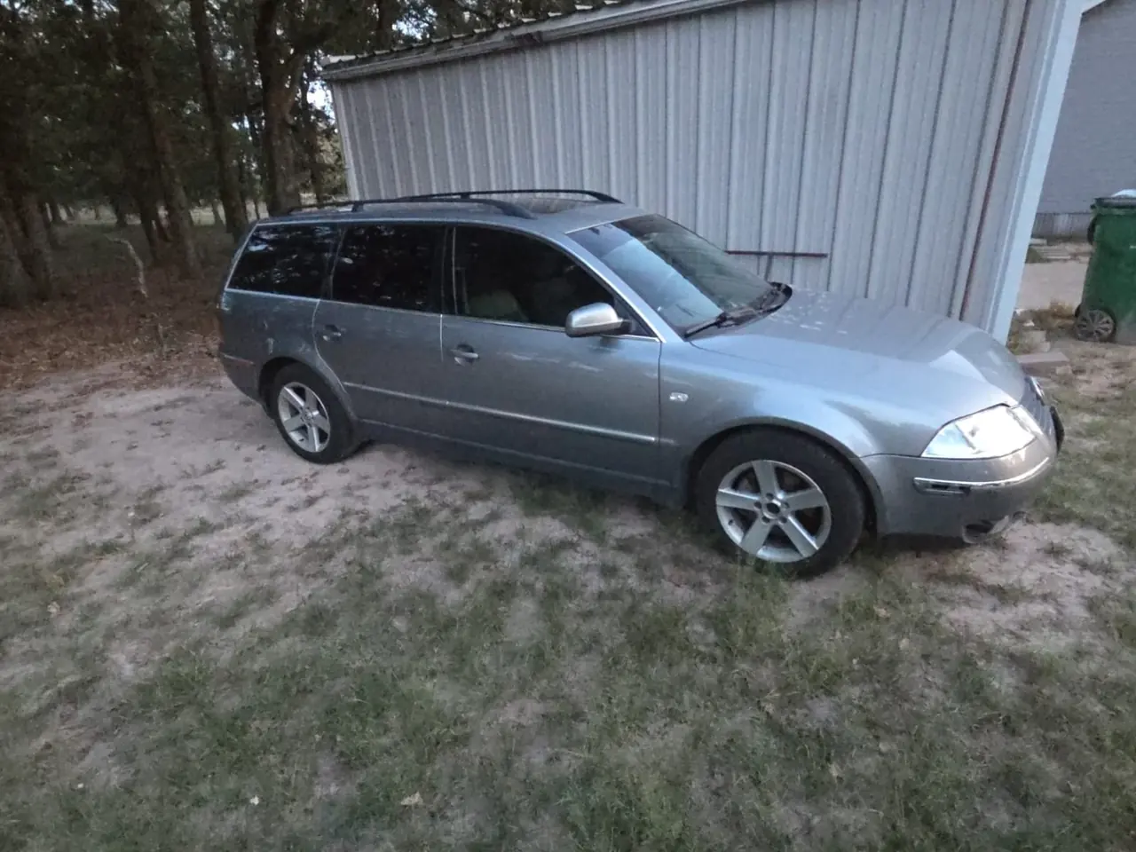 Silver Volkswagen Passat wagon parked on grass for junk car removal