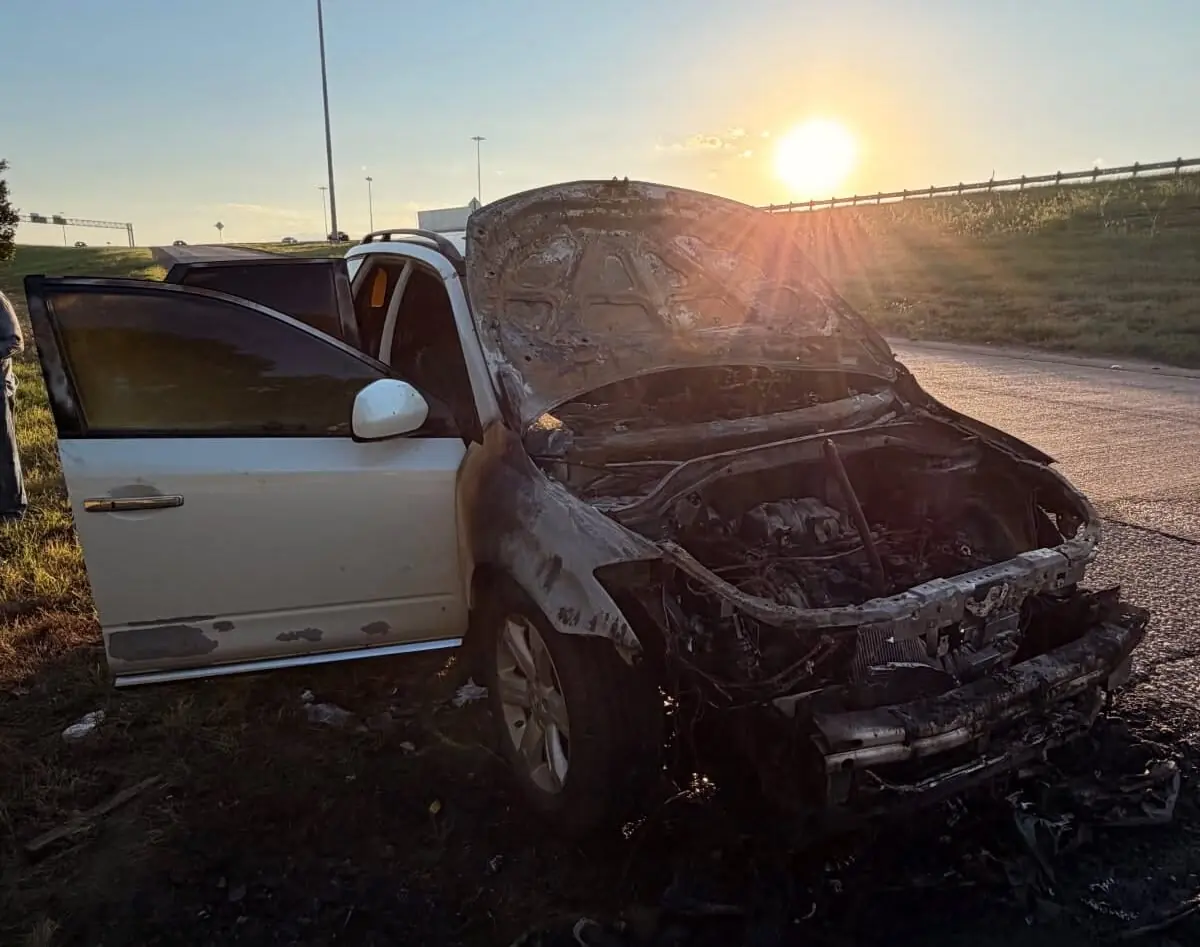 Fire-damaged burned car with the hood open, bought as a junk car