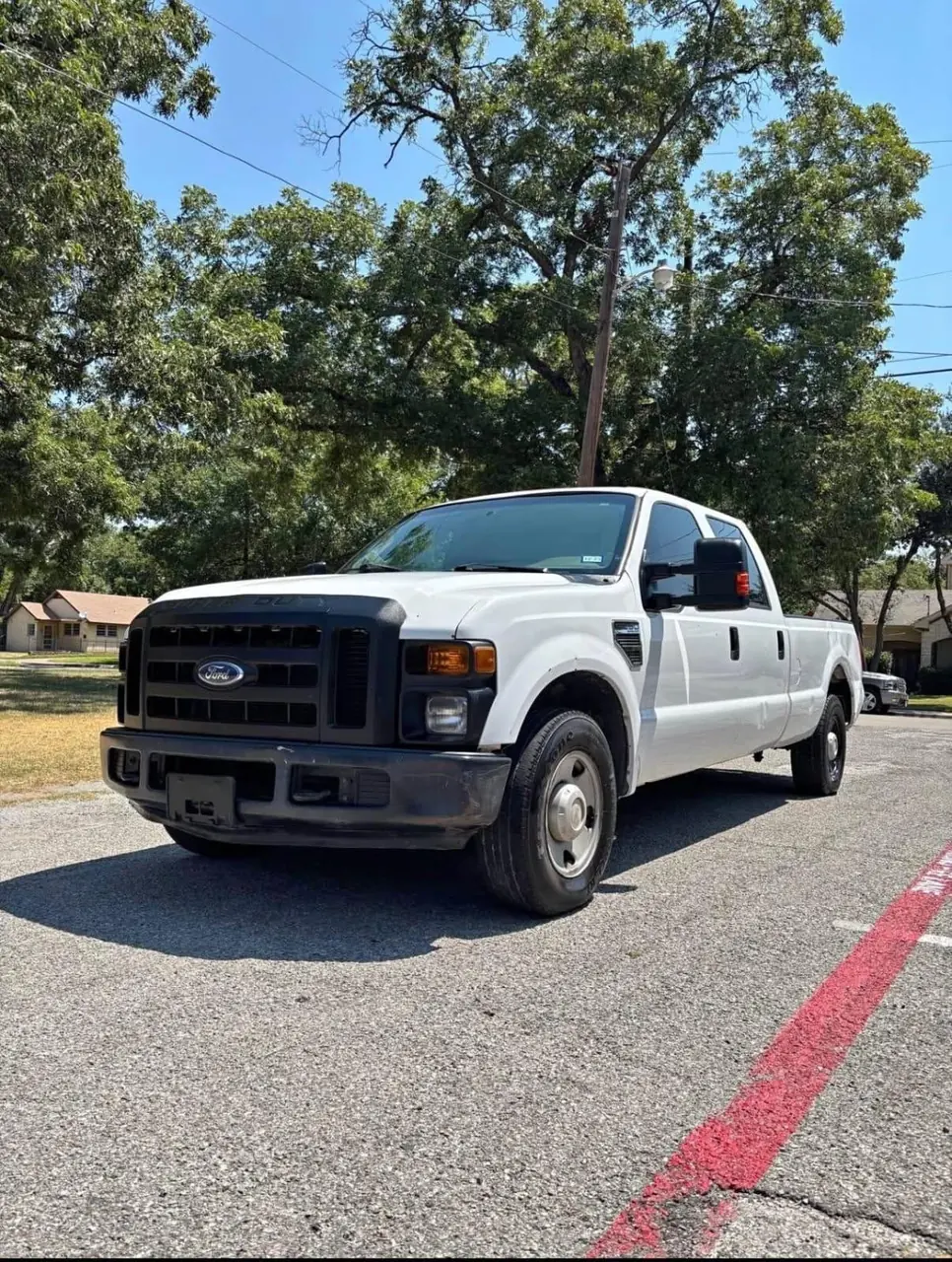 White Ford F-250 work truck parked in a lot, cash for trucks in Dallas