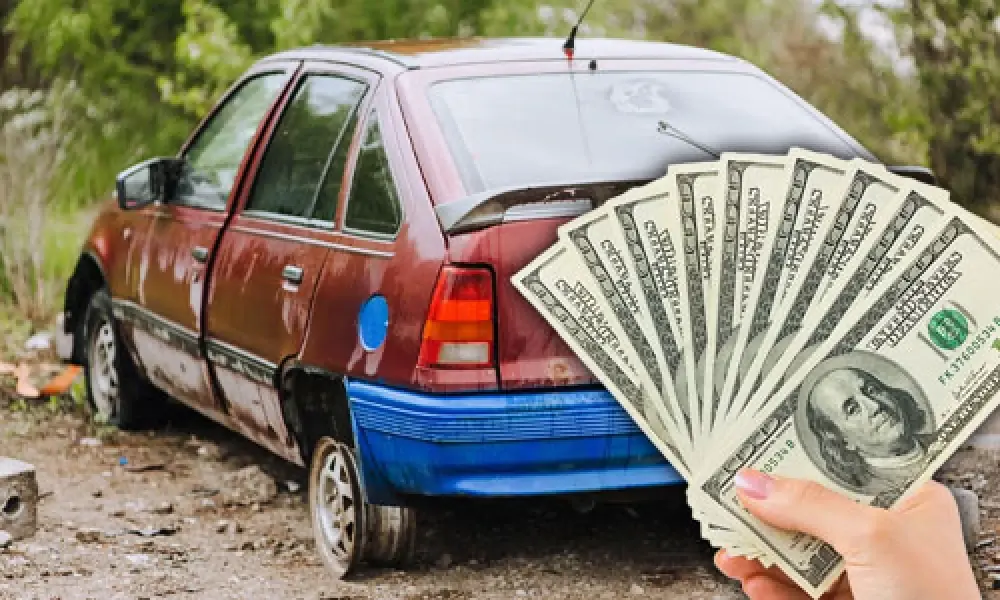 Rusty red hatchback with a fan of cash, cash for junk cars