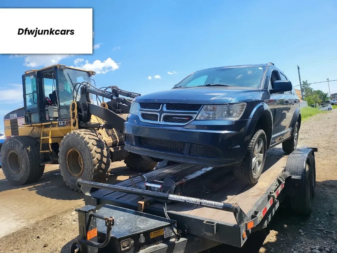 Dodge Journey SUV picked up for junk car removal on a trailer